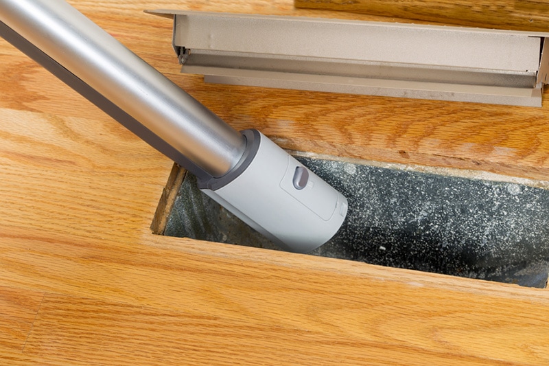 vacuuming an air duct, Furnace Maintenance Tips